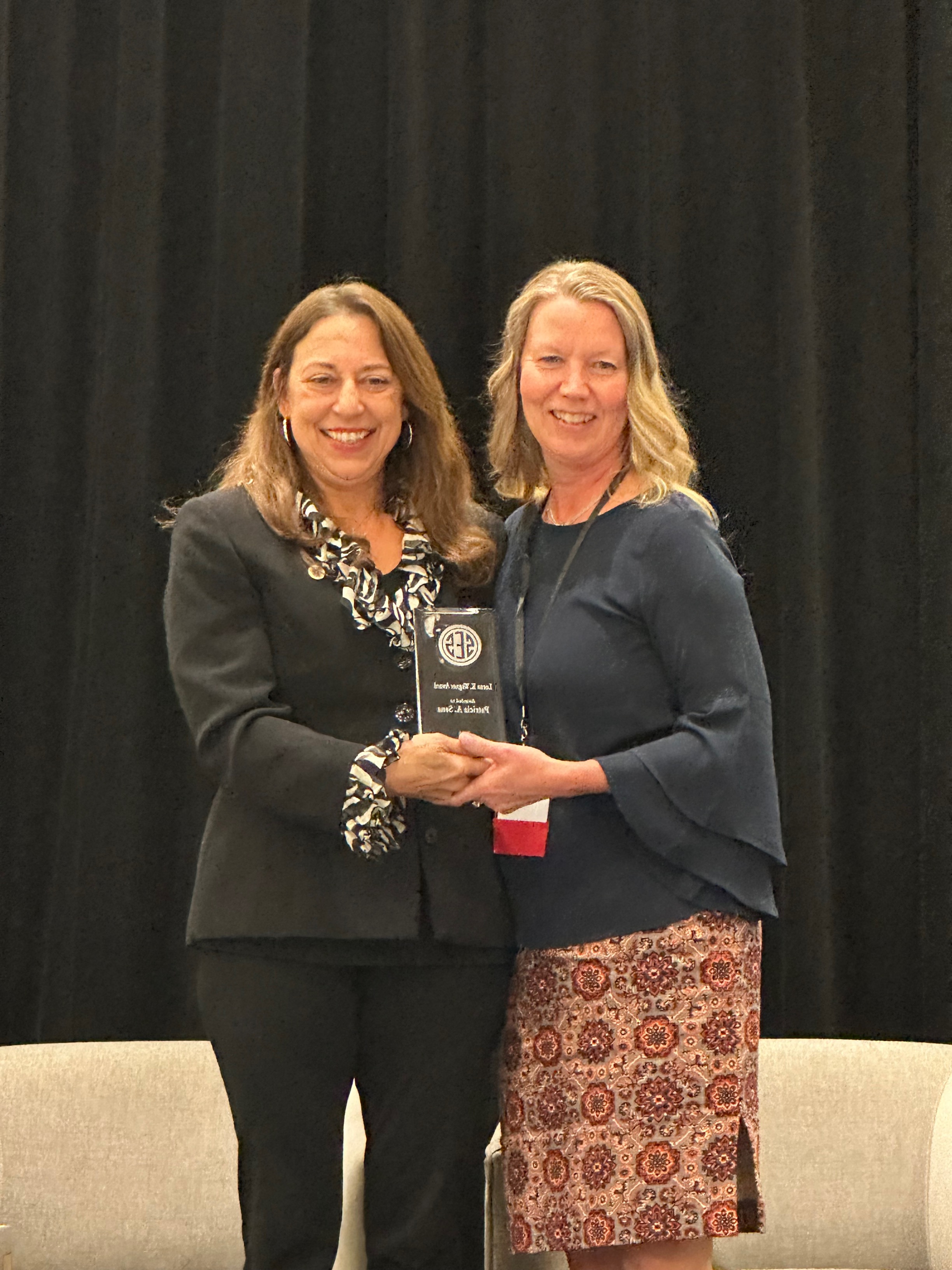 SES President Karen Reczek presents the Lorne K. Wagner Award to Tricia Sena