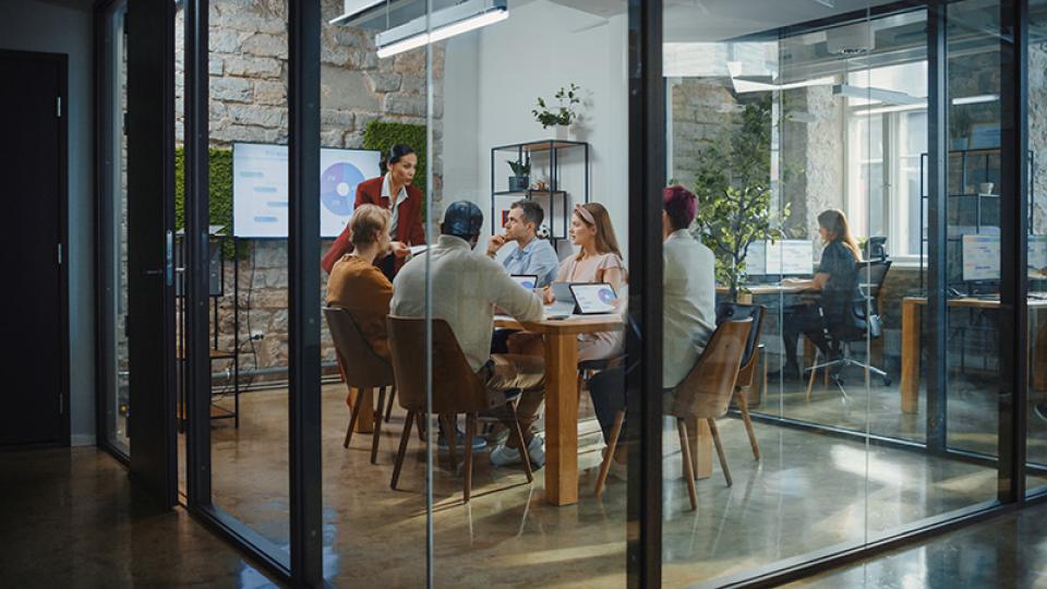 Office Conference Room Meeting- Female Chief Executive Talking to a Diverse Team of Professional Businesspeople