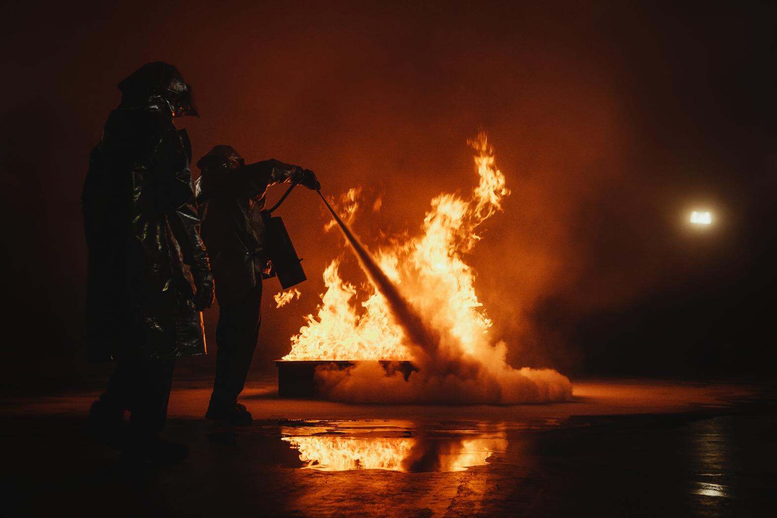 Firefighters extinguish a fire in a laboratory environment