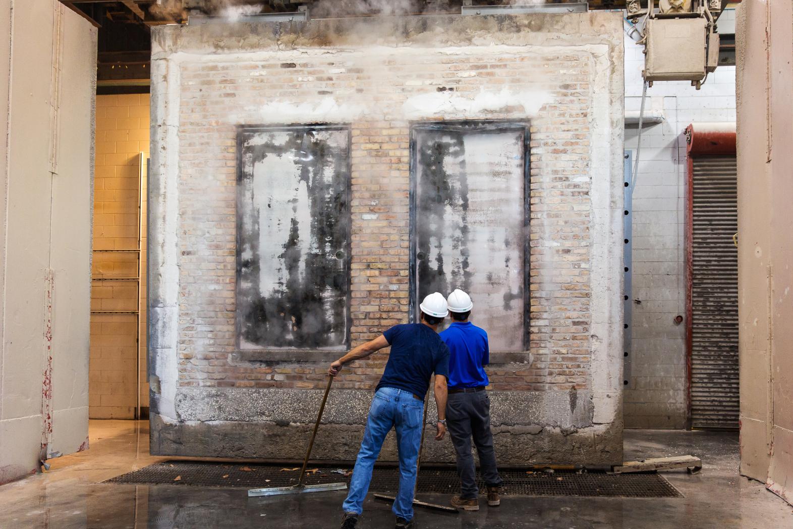 Two engineers inspecting fire doors during fire door safety test