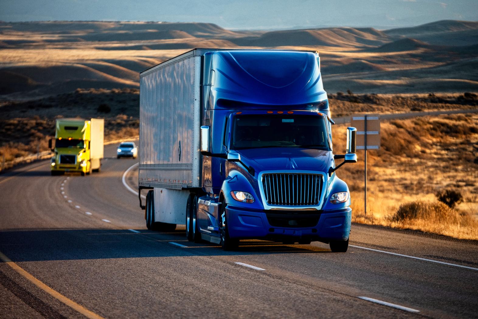 Two trucks on a desert highway