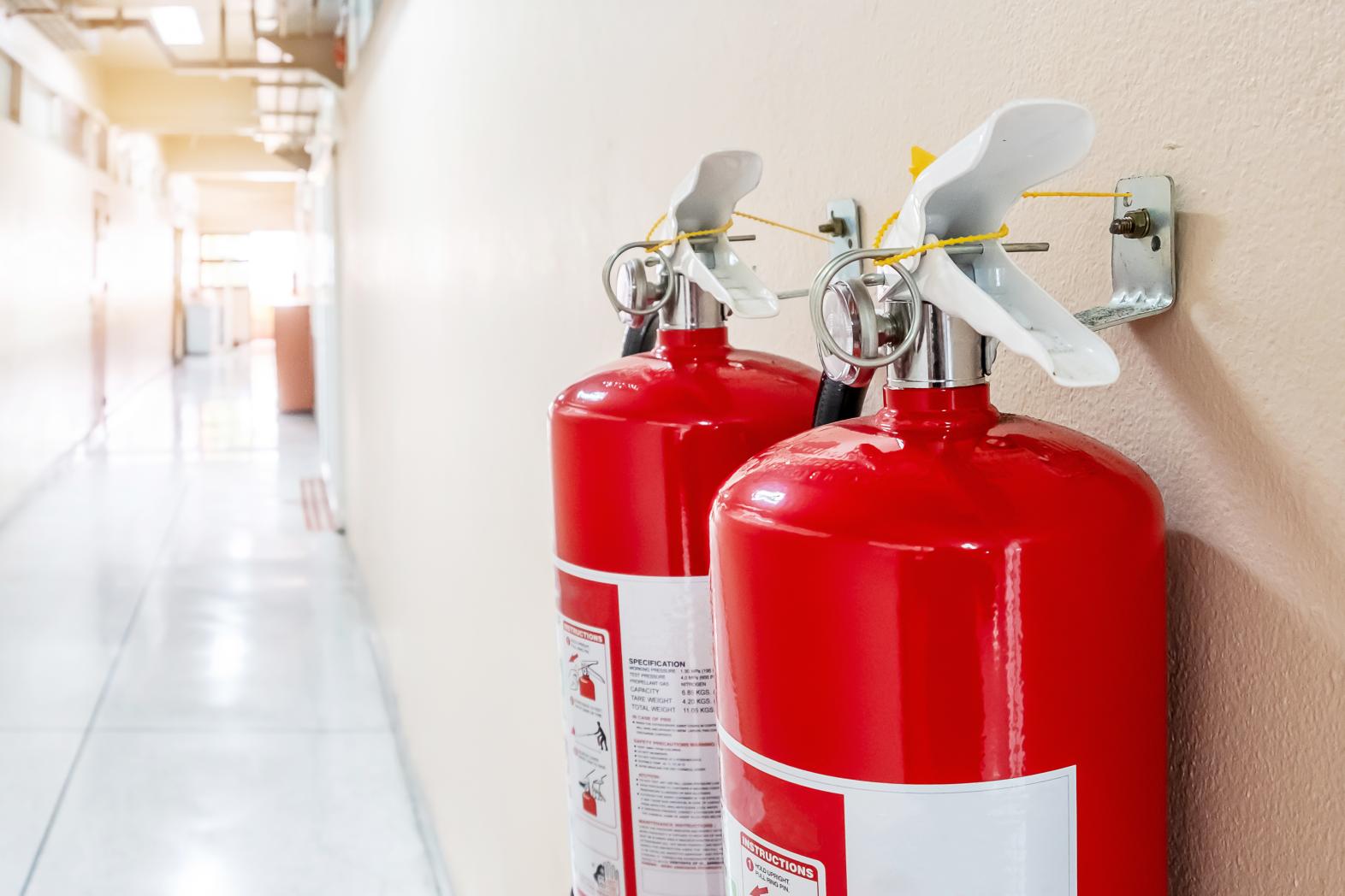 Fire extinguishers hanging in a hallway