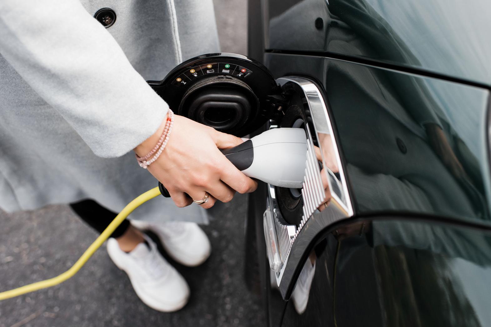 Woman charging EV