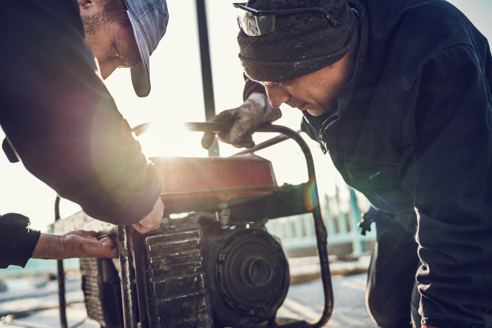 Two men working on generator