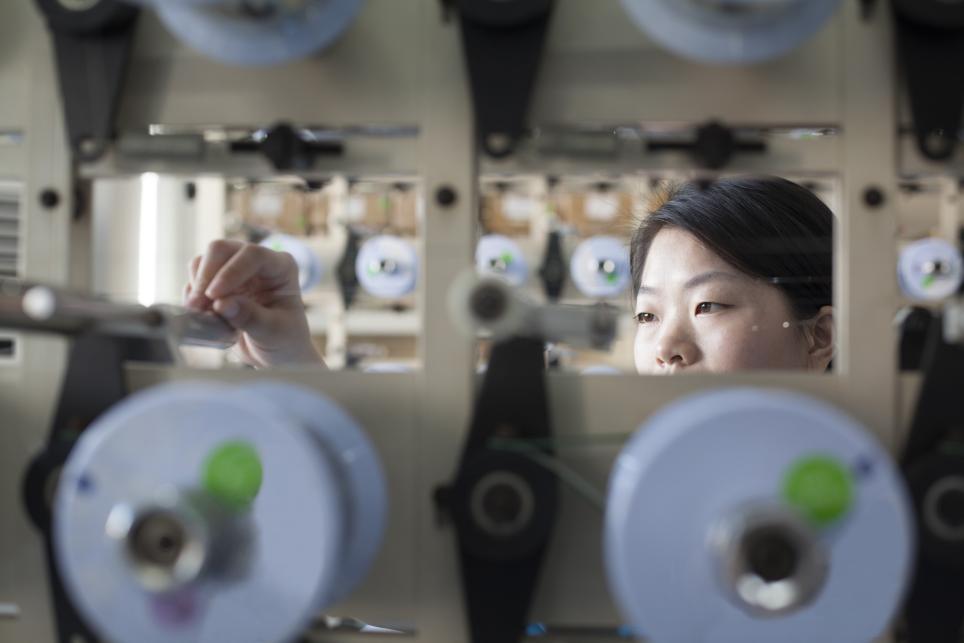 Woman adjusts electrical equipment