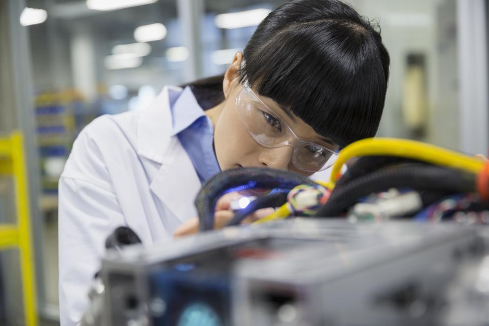 Engineer examining robotic technology in a laboratory setting