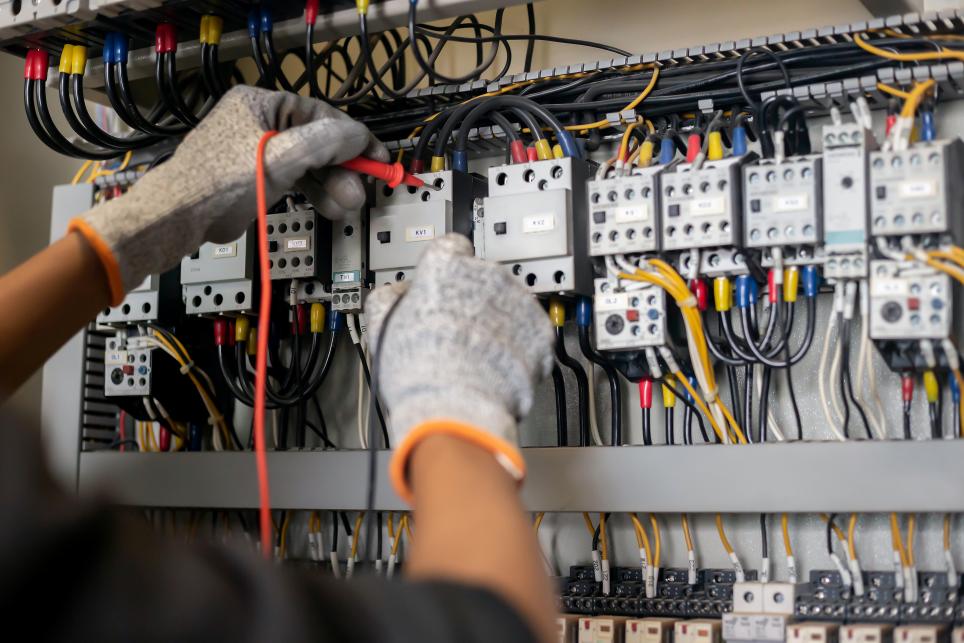 Electrical engineer testing connections
