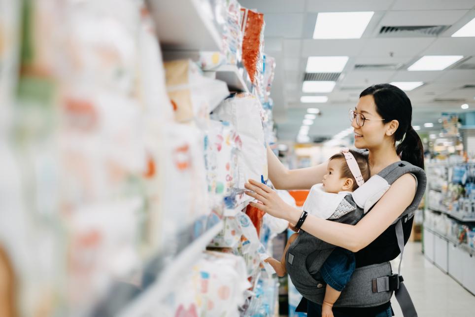 Mom shopping in grocery store with baby