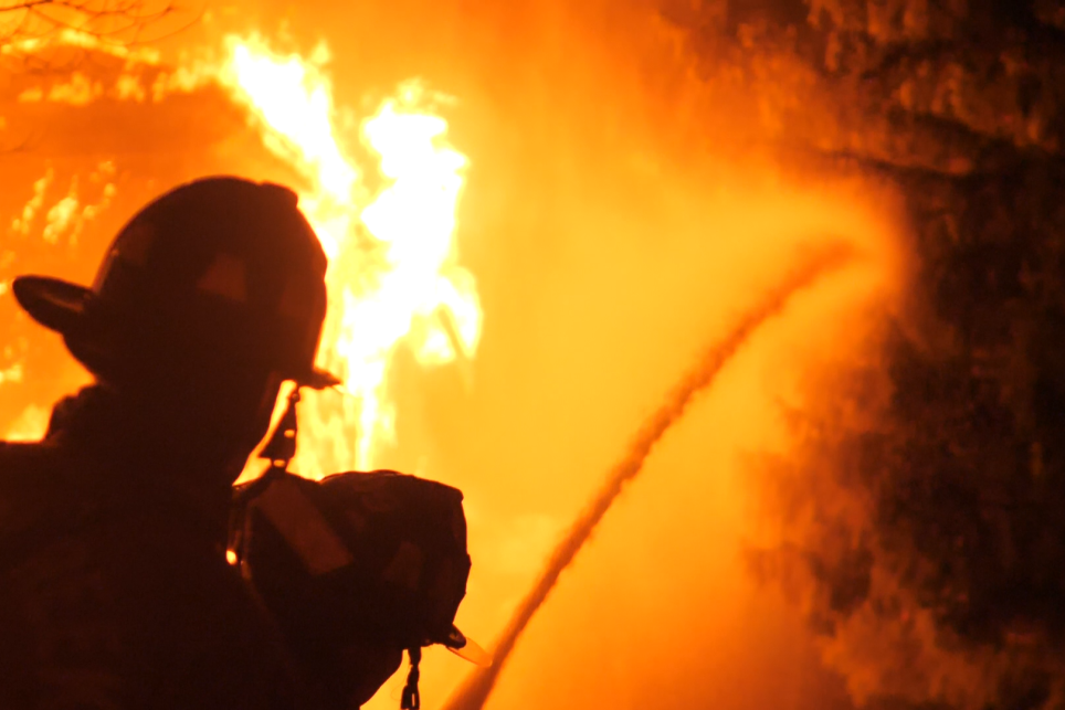 Firefighter attacking fire