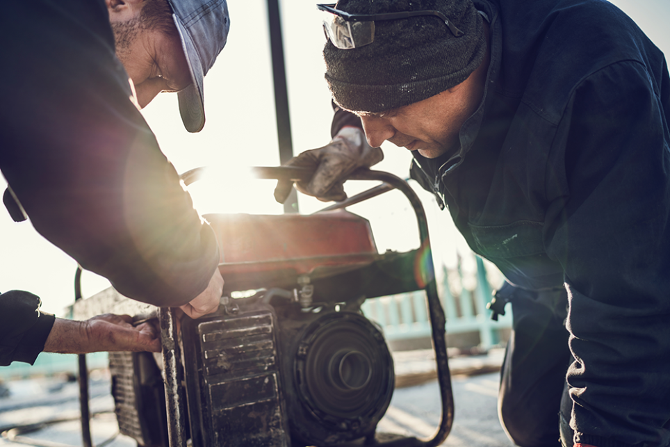 People operating portable generator