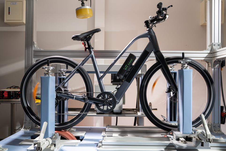 Black eBike in test rack.