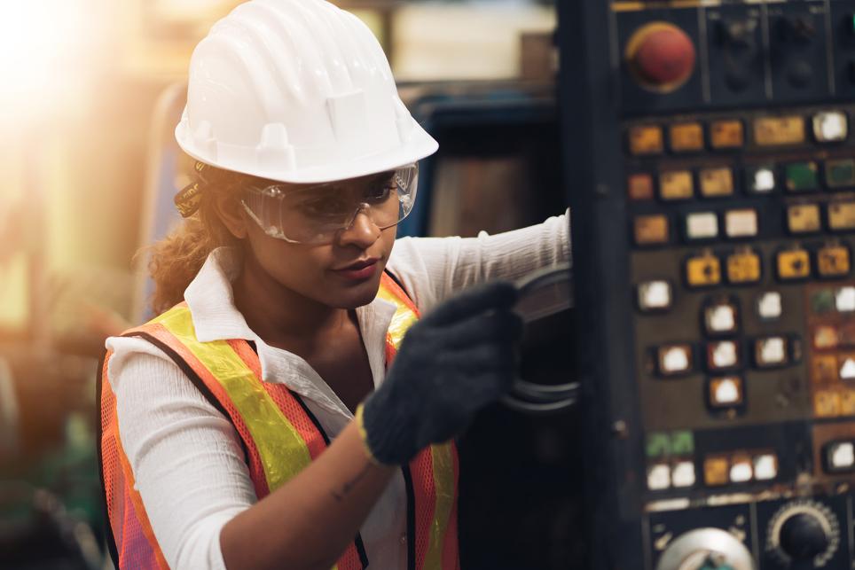 Female Engineer working on industrial control panel