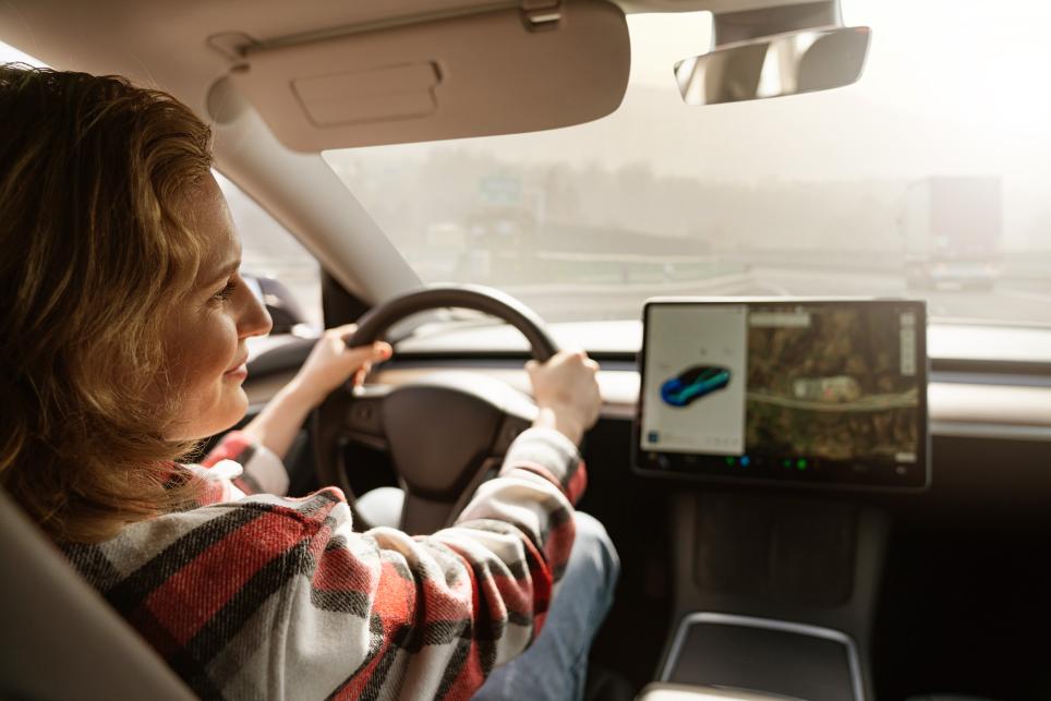 Woman driving autonomous vehicle