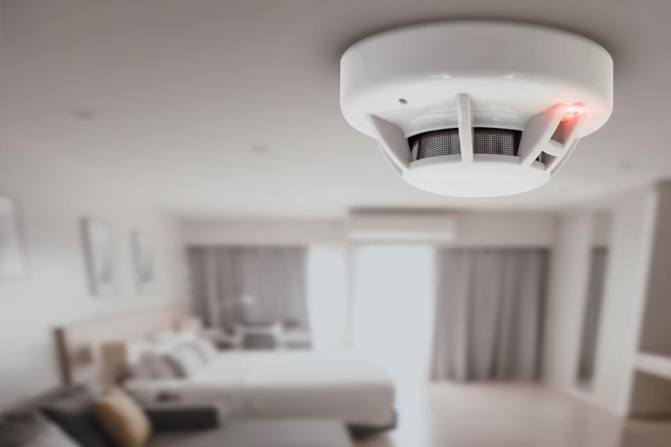 CO detector mounted on a bedroom ceiling.