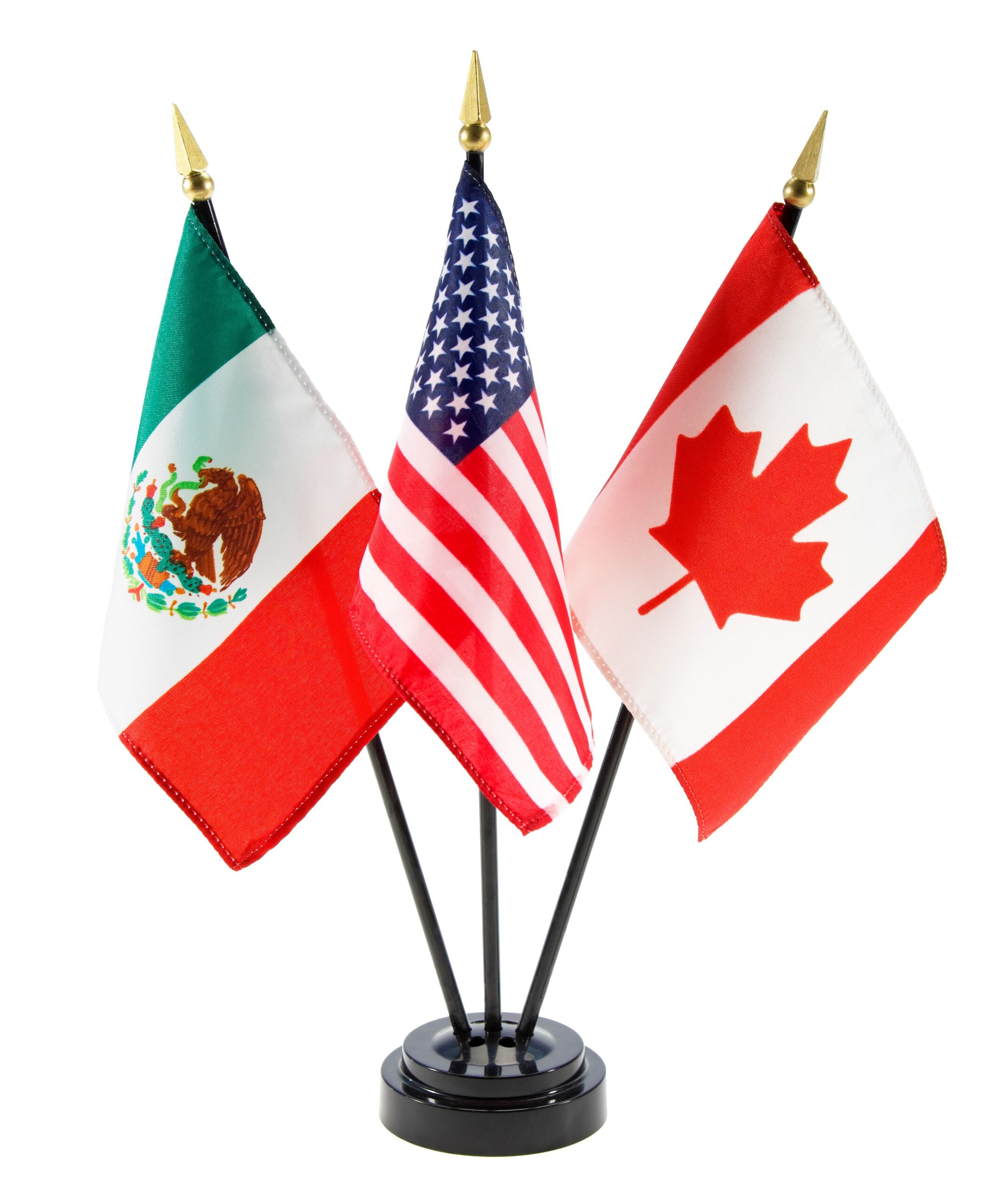 Three small flags on a stand: the Mexican flag on the left, the United States flag in the center, and the Canadian flag on the right, all with gold-tipped poles.