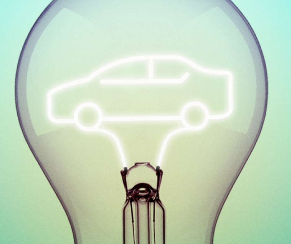 A glowing outline of a car is formed by the filament inside a clear light bulb, symbolizing ideas or innovation related to automobiles or electric cars.