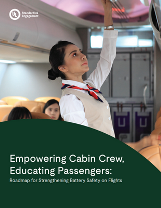 A flight attendant in uniform reaches up to an overhead compartment inside an airplane. The text overlay reads, "Empowering Cabin Crew, Educating Passengers: Roadmap for Strengthening Battery Safety on Flights.