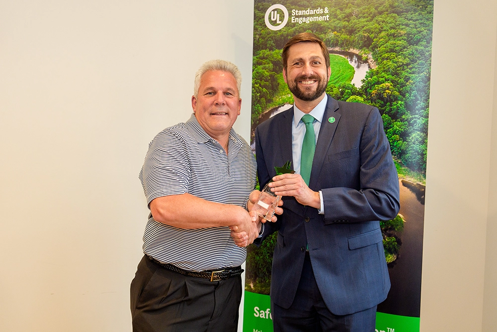 two men shaking hands and smiling